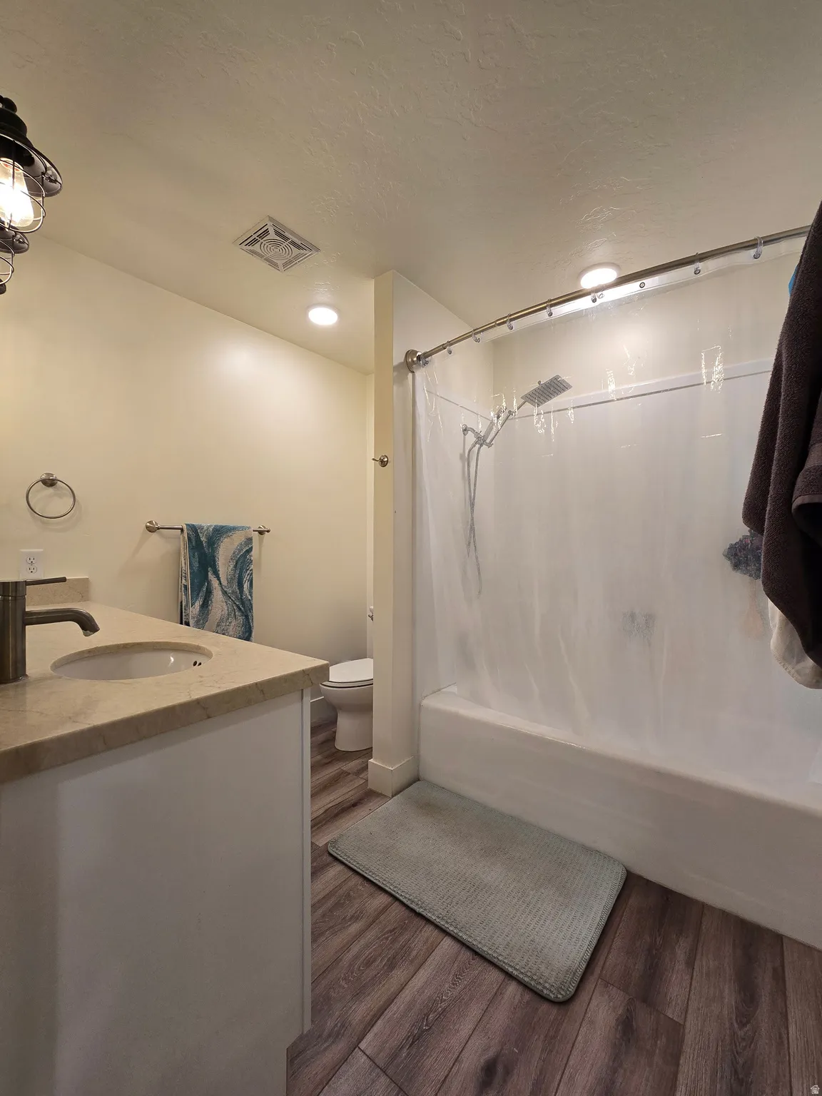 Bathroom featuring a white vanity with a light-toned countertop and an undermount sink