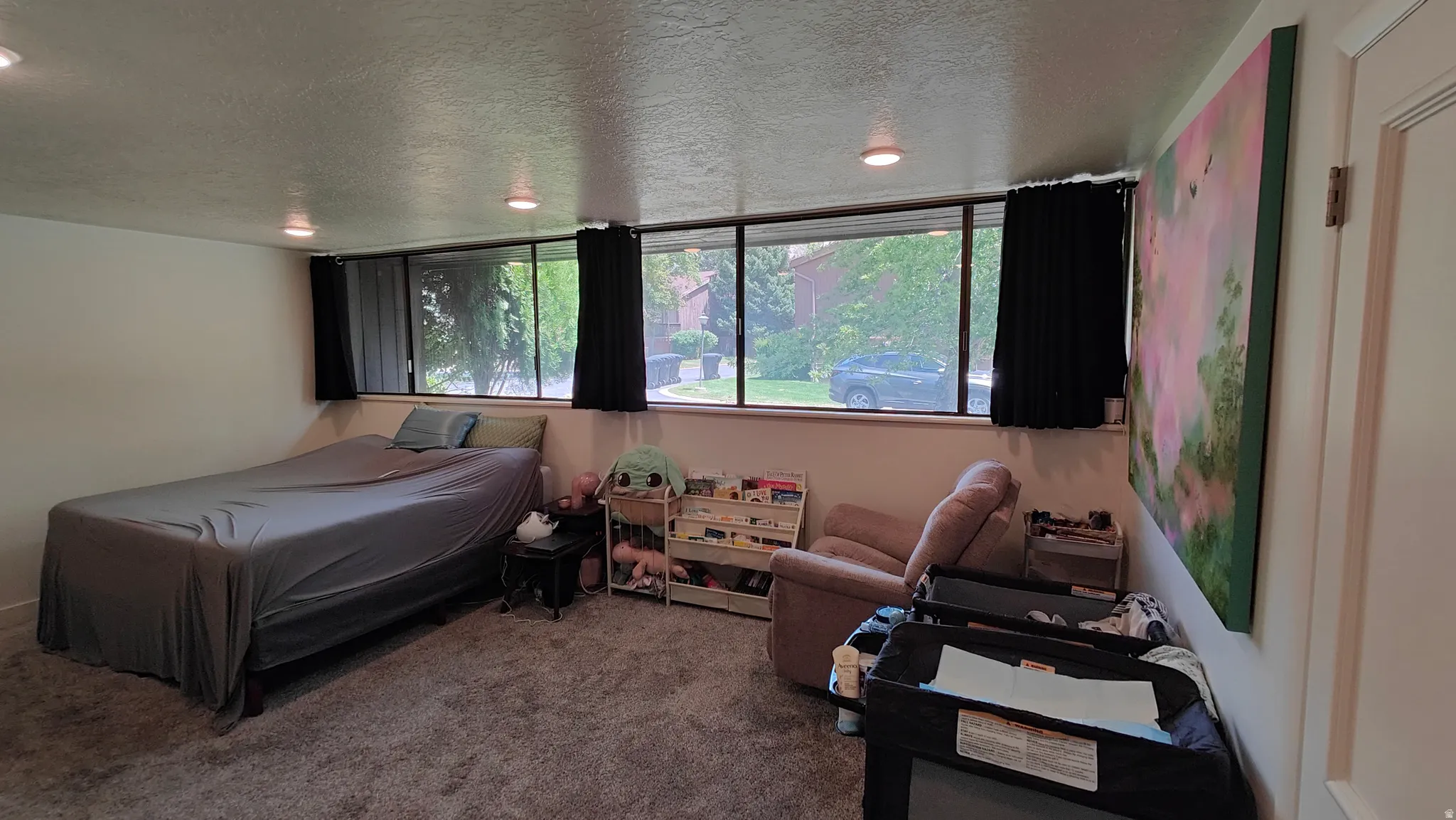 Wall-to-wall carpeting with recessed lighting and a row of horizontal windows