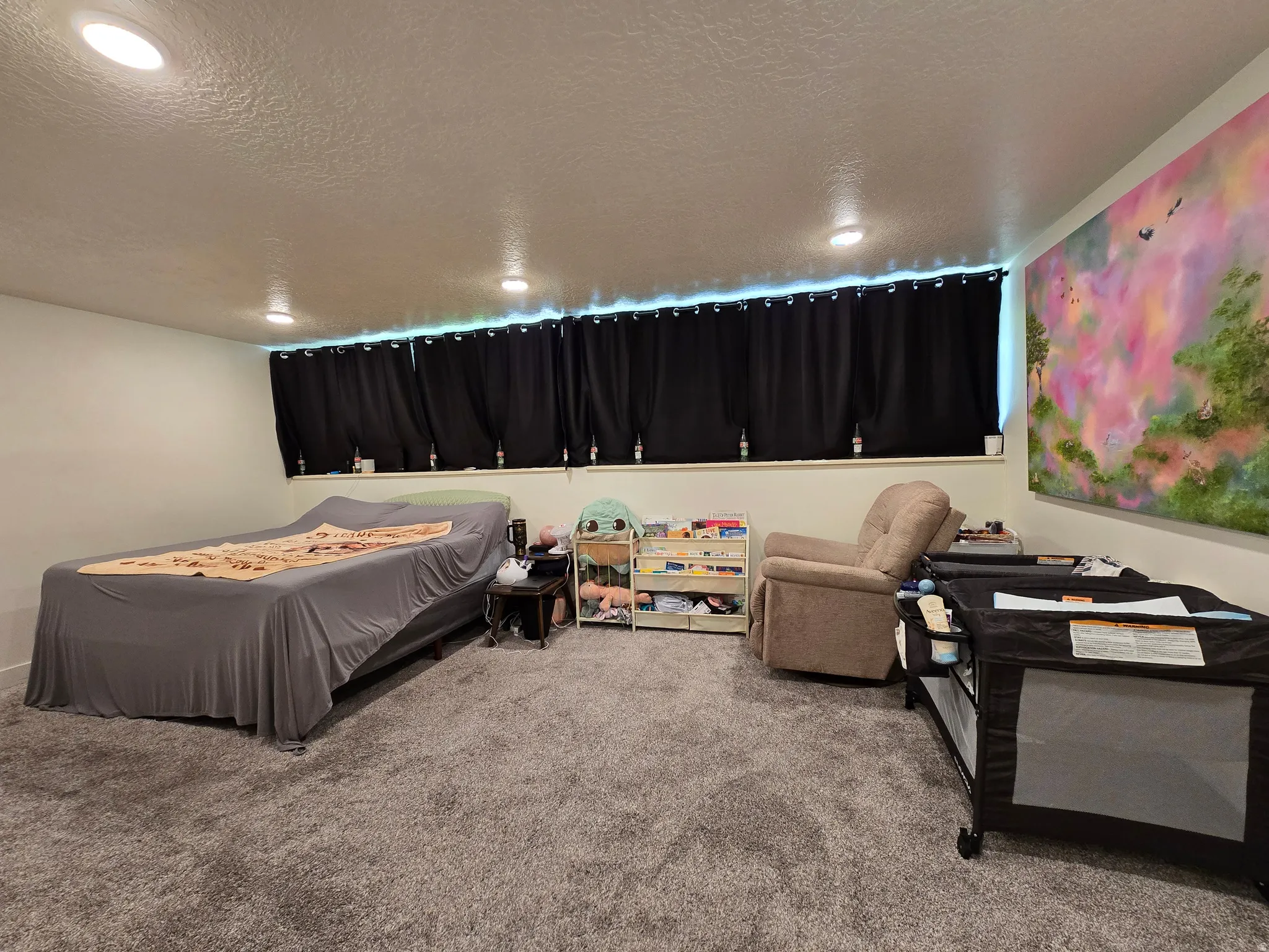 Carpeted interior space featuring recessed lighting, a window with blackout curtains, and light-colored walls