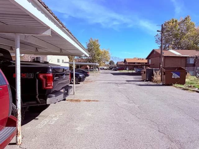 Off-street parking area featuring multiple covered carport structures
