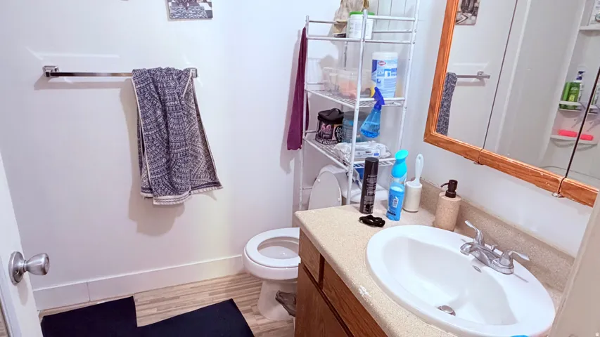 Bathroom vanity with an integrated white sink, chrome faucet, and a light-toned countertop