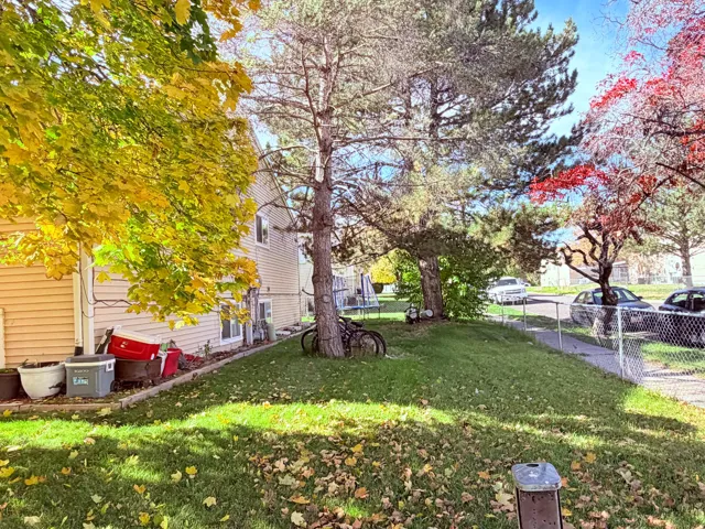 Manicured lawn with mature trees and vibrant foliage
