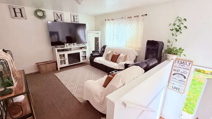 Living area with textured carpeting and white walls