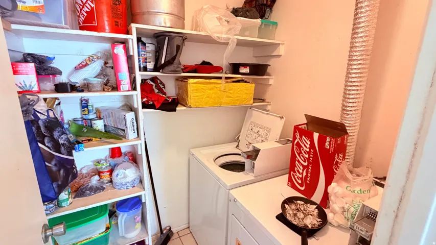 Utility area featuring a top-load washing machine, a dryer, and built-in shelving