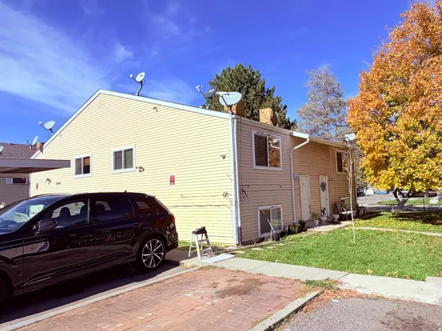 Duplex with beige siding and white window frames