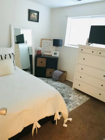 Carpeted room featuring a white-trimmed window, recessed lighting, and a neutral color palette