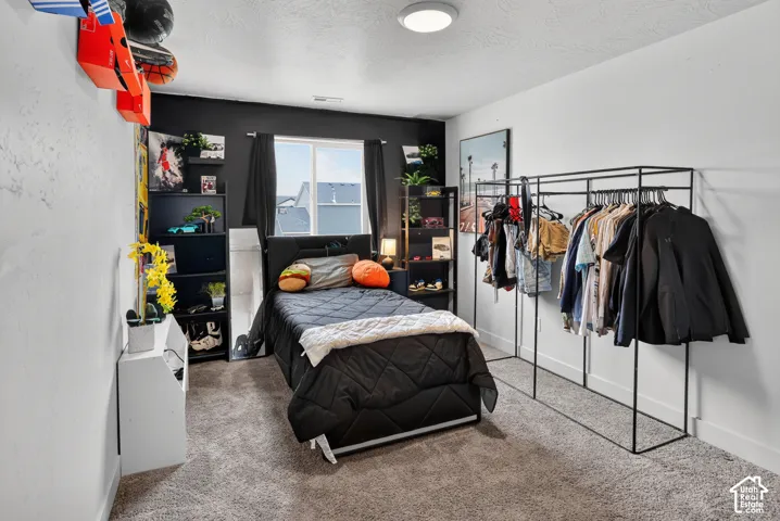 Carpeted room with a black accent wall