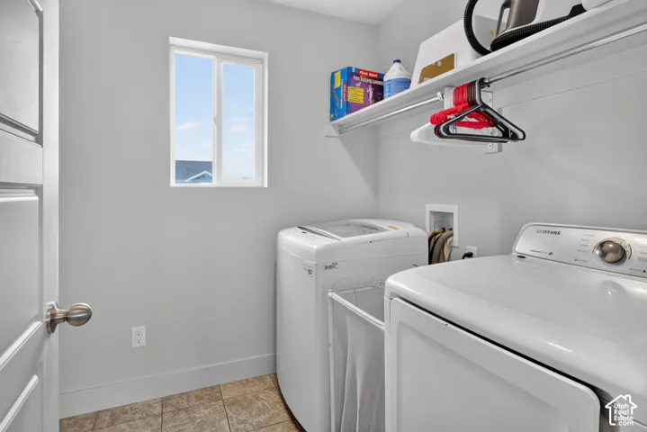 Dedicated laundry area featuring a window, built-in shelving, and a wall-mounted hanging rod