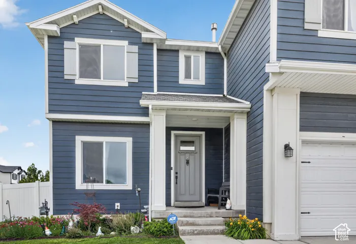 Two-story residence featuring blue horizontal siding with white trim accents