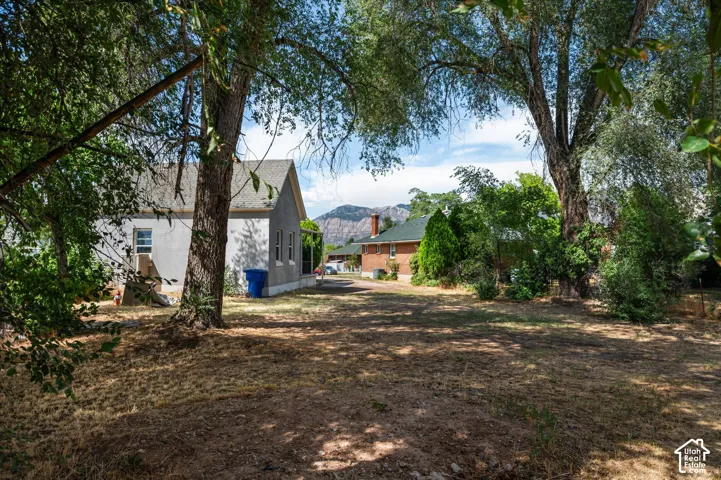 Expansive property featuring mature trees and a substantial yard space