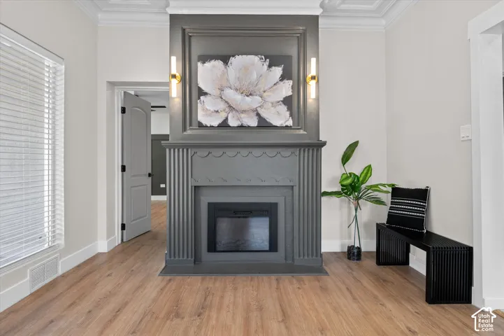 Central fireplace featuring a gray mantel with decorative fluting and a recessed electric insert