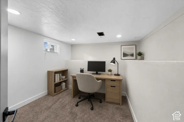 Dedicated workspace featuring recessed lighting and a window with blinds