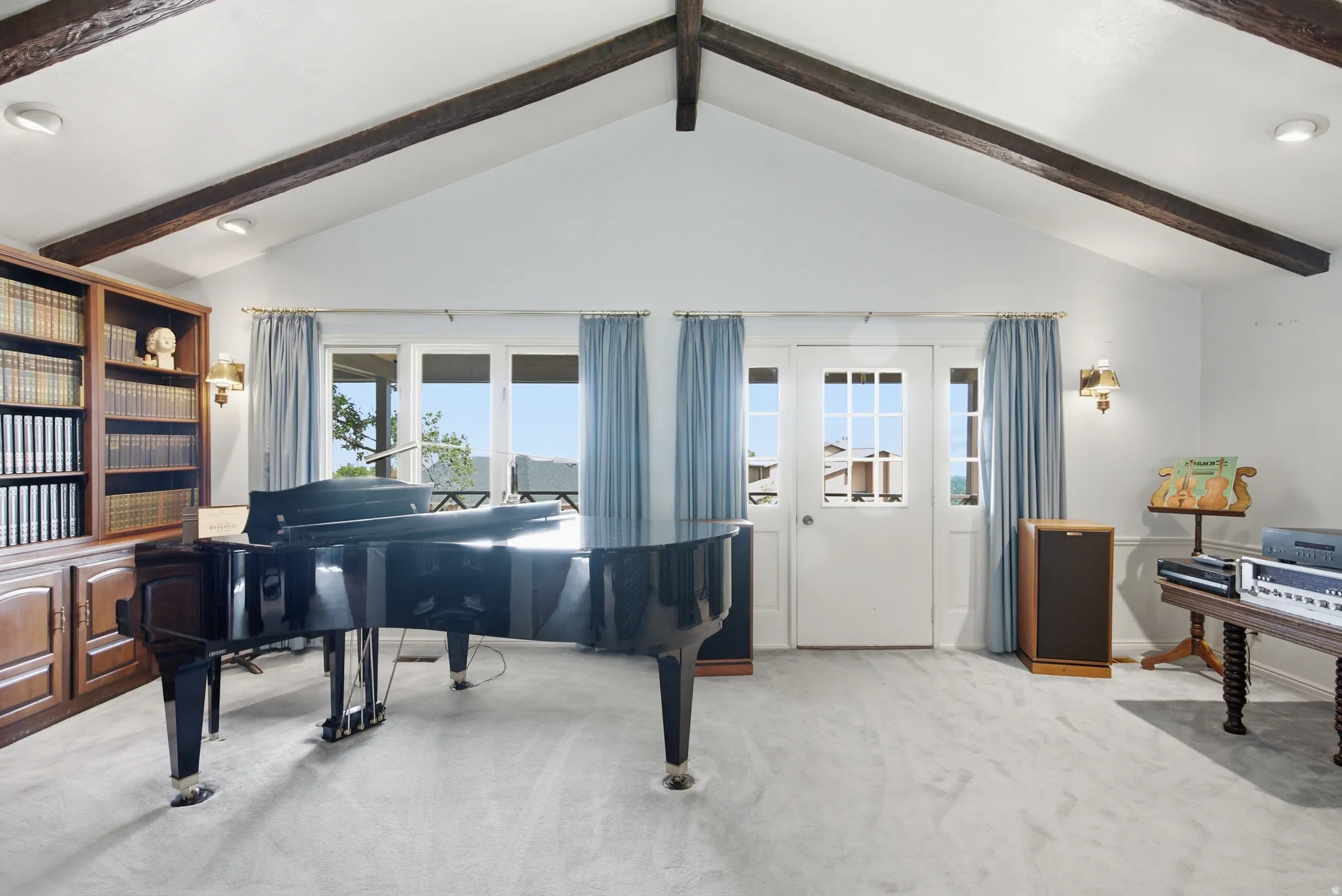 Vaulted ceiling featuring exposed wood beams