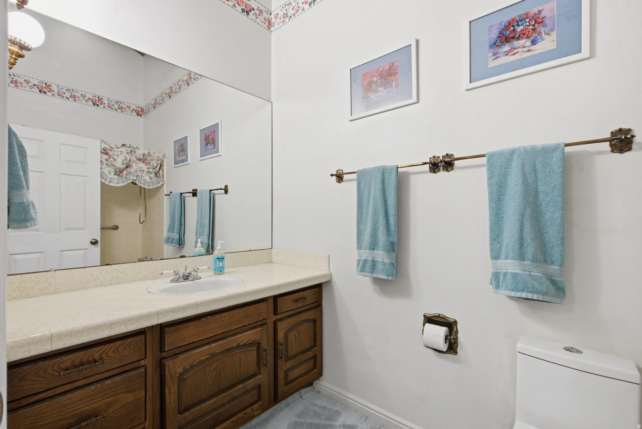 Bathroom featuring a vanity with dark wood-finish cabinetry and a light-toned countertop