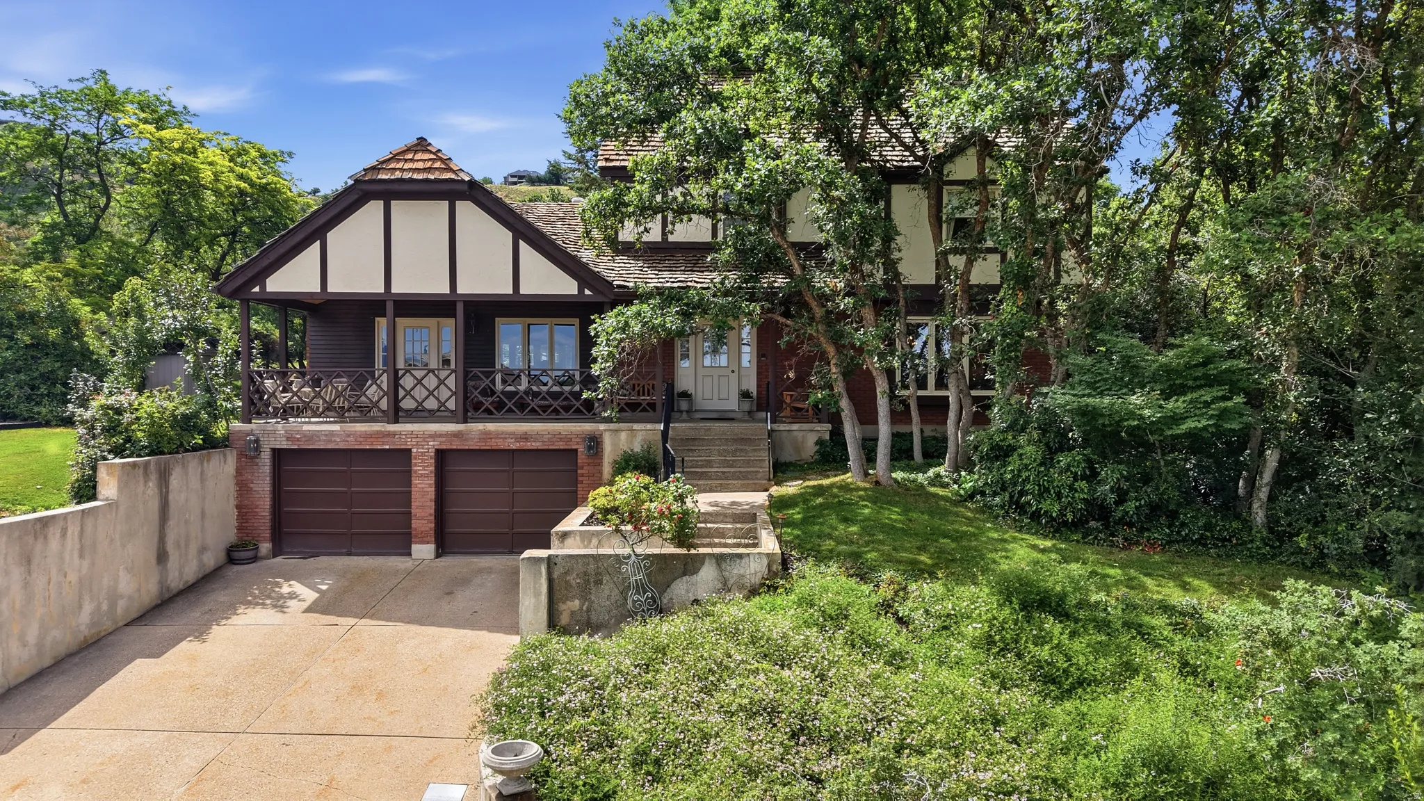 Tudor-style residence featuring a prominent gabled roof with terracotta-hued tiles