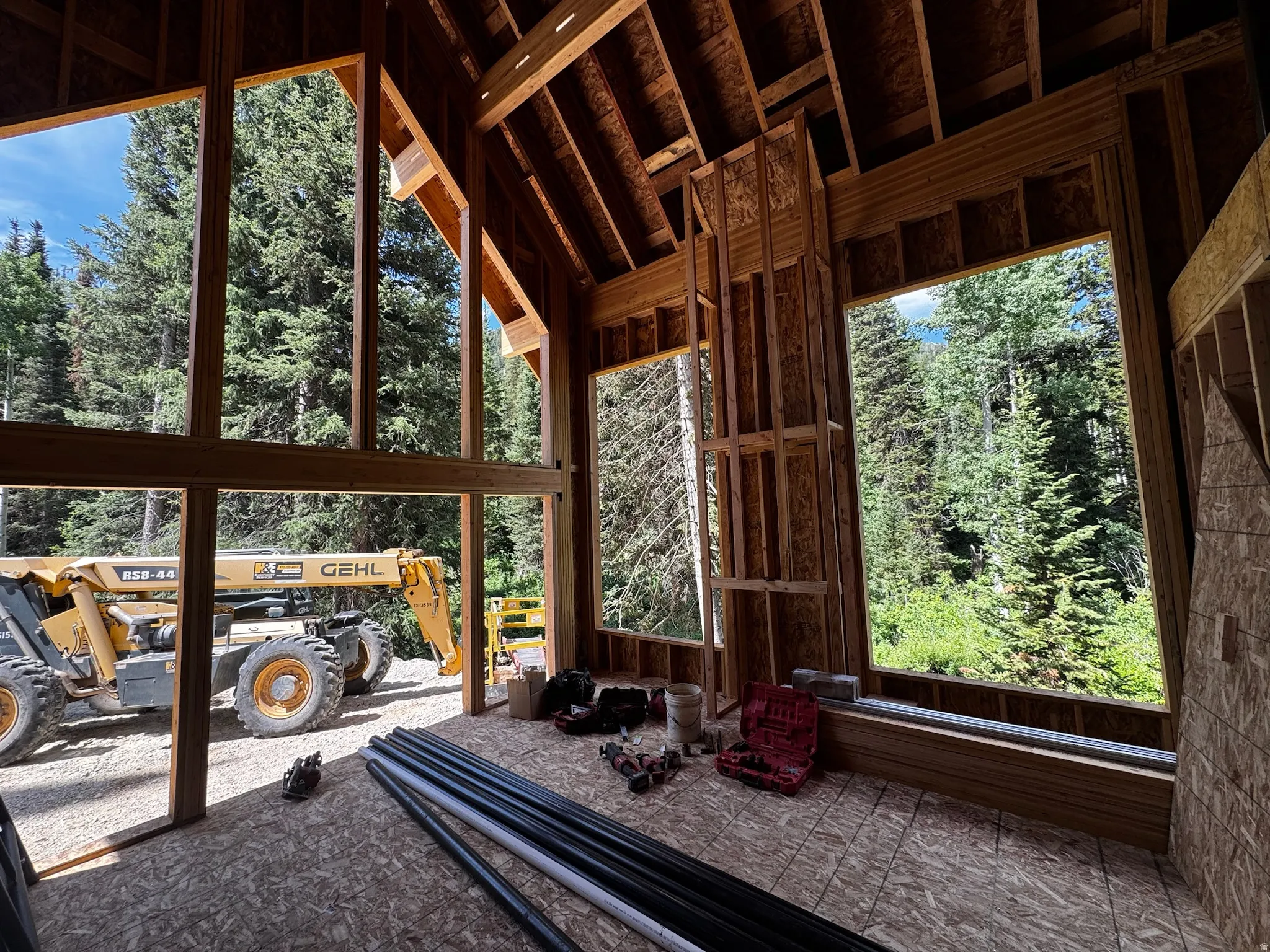 Construction progress highlighting the expansive glass openings designed to capture natural light and peaceful wooded views.