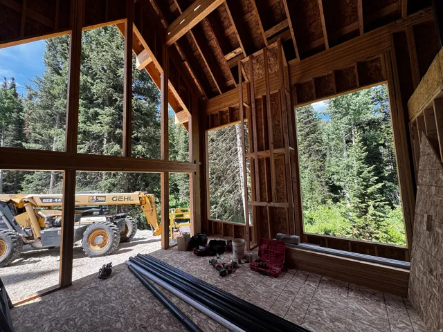 Construction progress highlighting the expansive glass openings designed to capture natural light and peaceful wooded views.