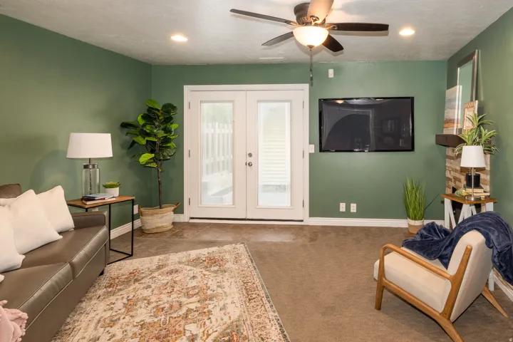 Spacious room featuring a ceiling fan with integrated lighting, recessed lighting, and a wall-mounted television