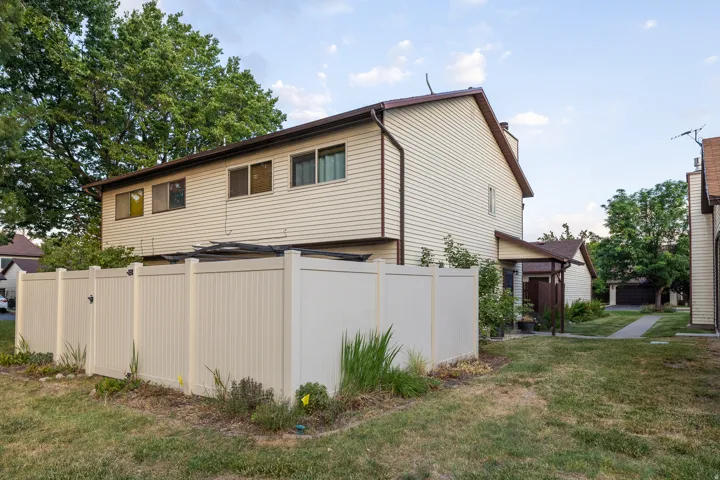Cream-colored siding exterior with brown trim and roofline