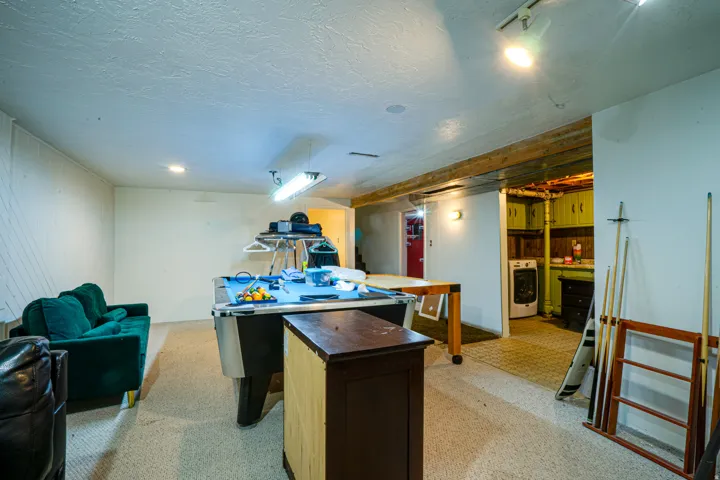 Spacious recreation room featuring track lighting and recessed ceiling lights