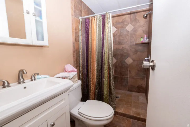 Bathroom featuring a white vanity with an integrated sink, brushed nickel faucet, and a wall-mounted medicine cabinet