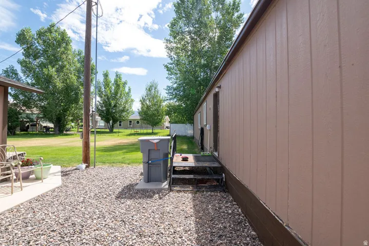 Light brown vertical siding with dark brown trim and a dark brown foundation