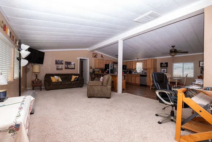 Spacious interior featuring neutral carpeting, light-toned walls, and white ceiling panels