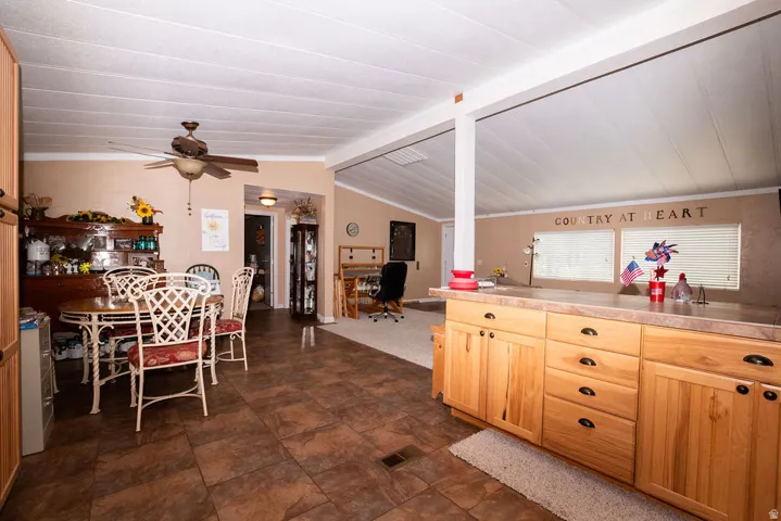 Kitchen featuring wood-finish cabinetry, a laminate countertop, and tile flooring
