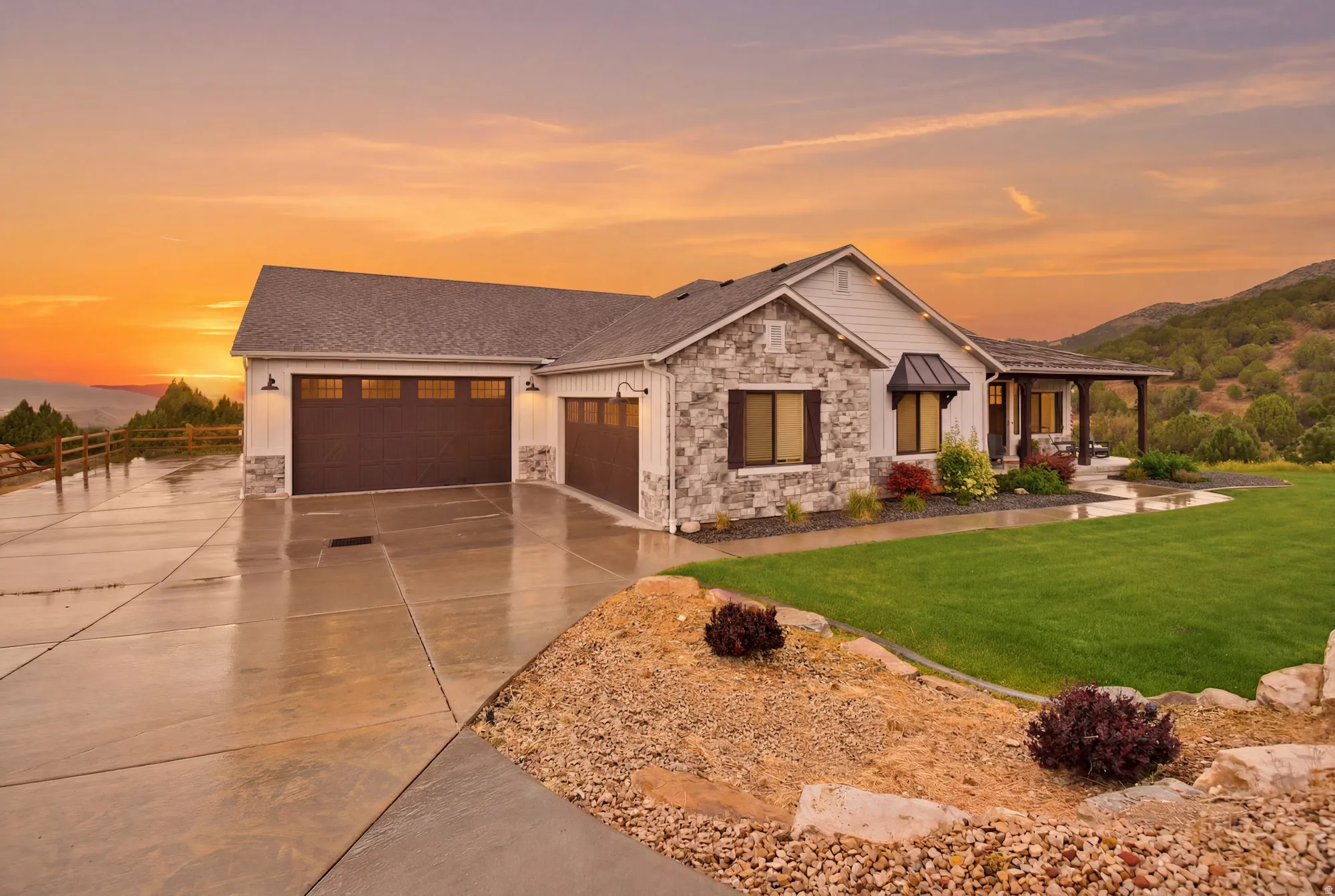 Ranch-style exterior featuring stone and horizontal siding, a covered entry, a multi-car driveway, and a manicured lawn