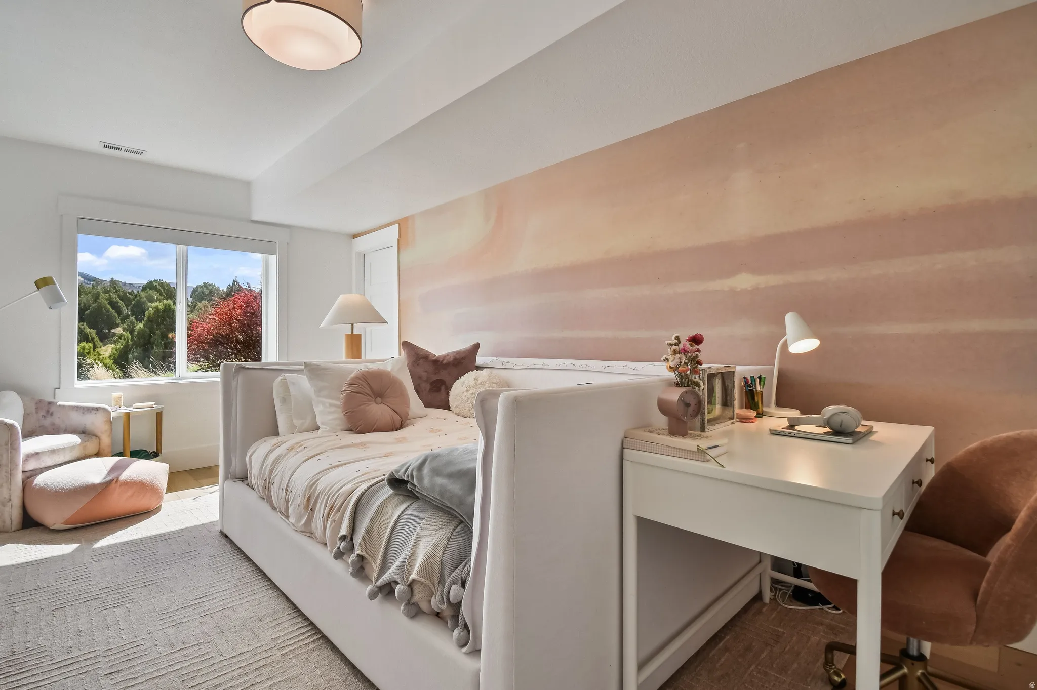 Spacious room with a large window, light-toned walls, and a recessed ceiling light fixture
