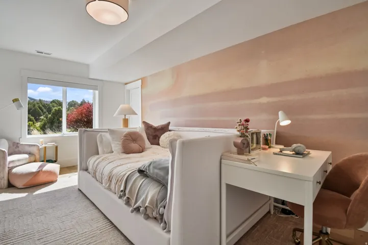 Spacious room with a large window, light-toned walls, and a recessed ceiling light fixture