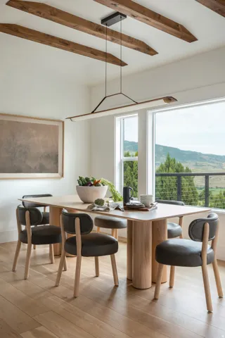 Dining area featuring exposed ceiling beams, a linear pendant light fixture, large picture windows, and wood-finish flooring