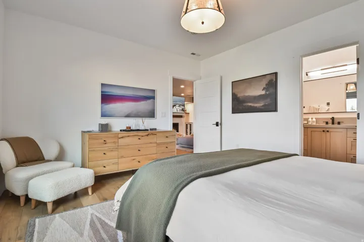 Hardwood-finish flooring and white walls with a contemporary ceiling fixture
