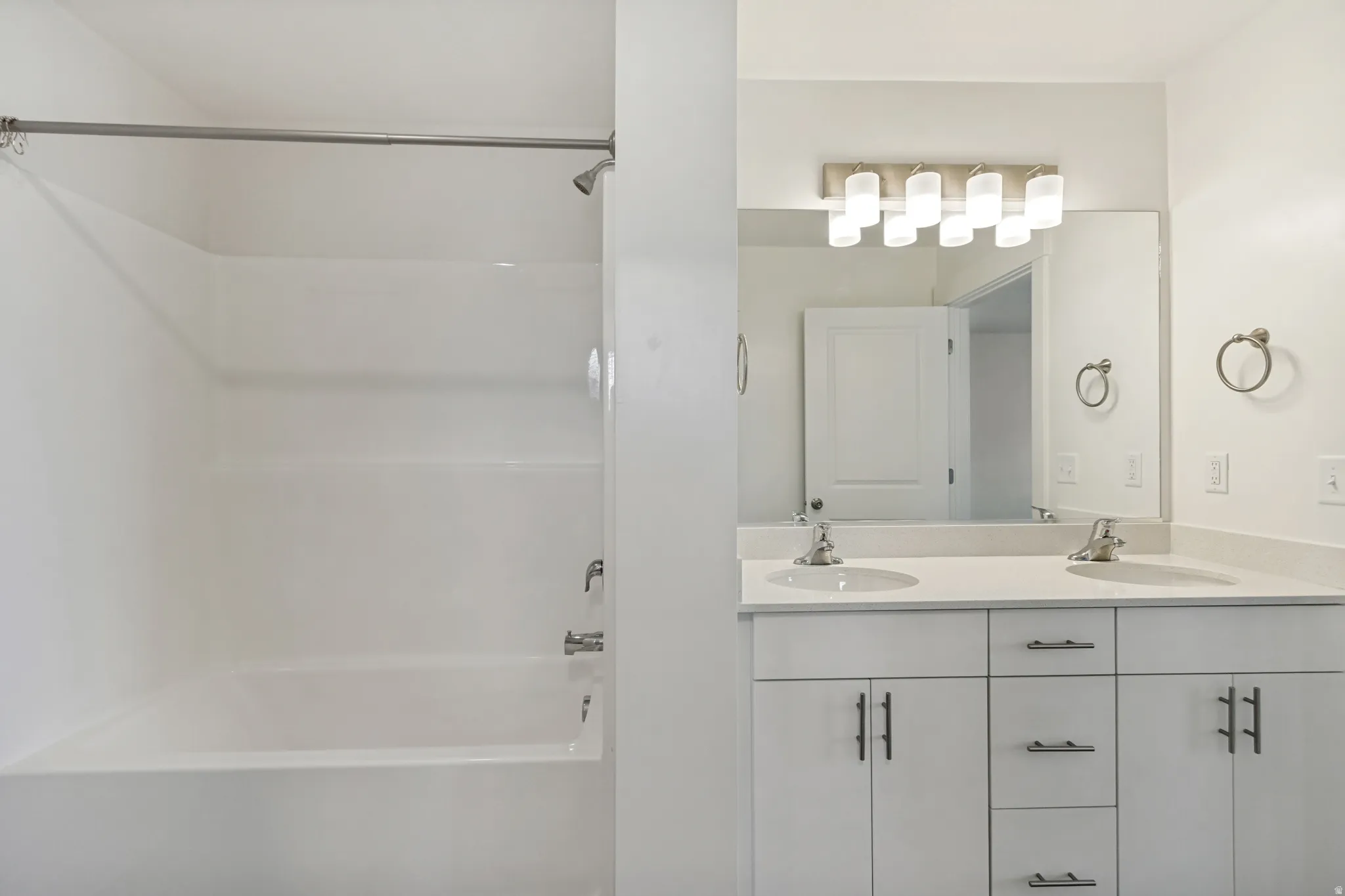 Mast bathroom featuring a double vanity with matching quartz countertops
