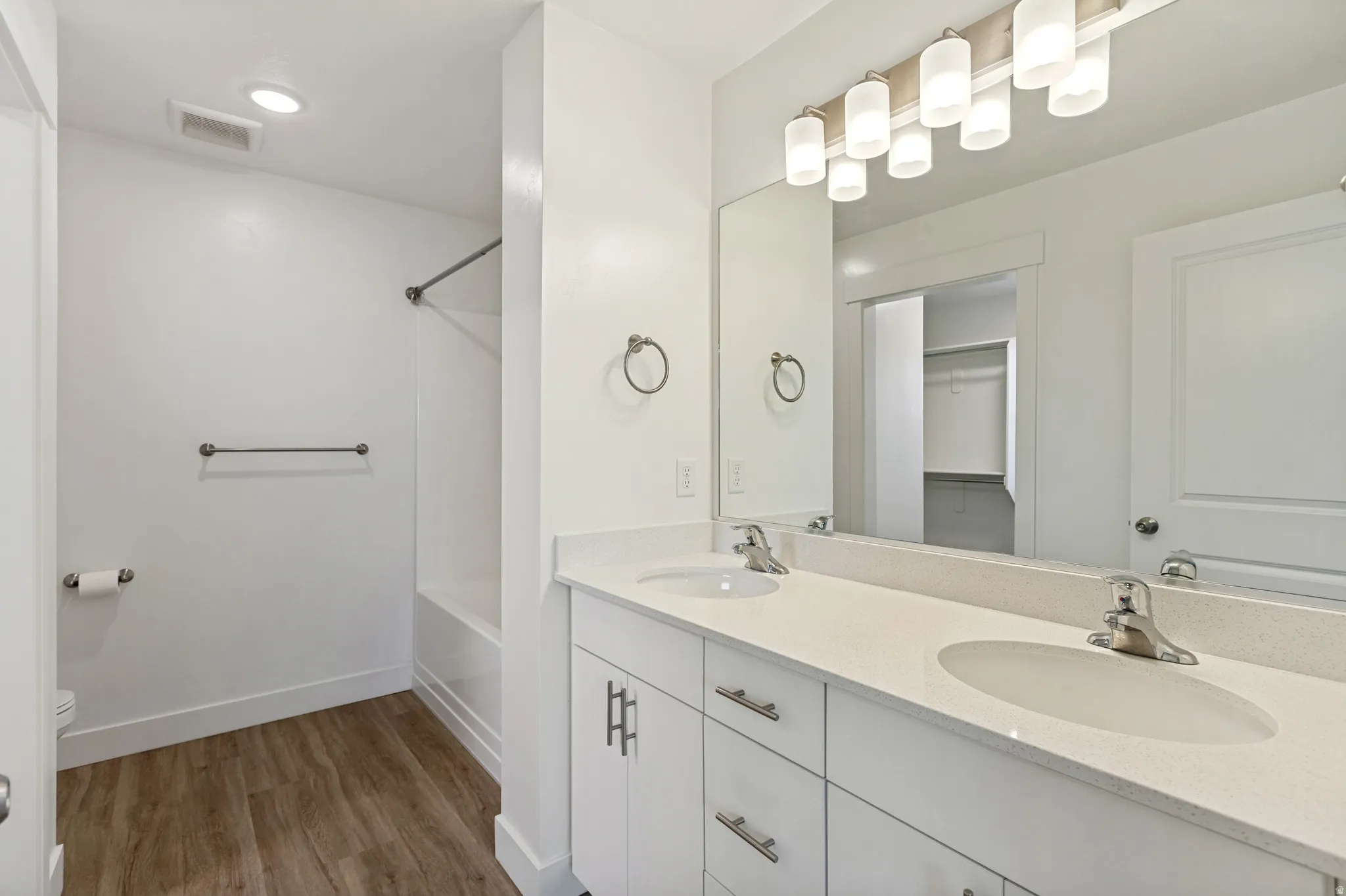Mast bathroom featuring a double vanity with matching quartz countertops