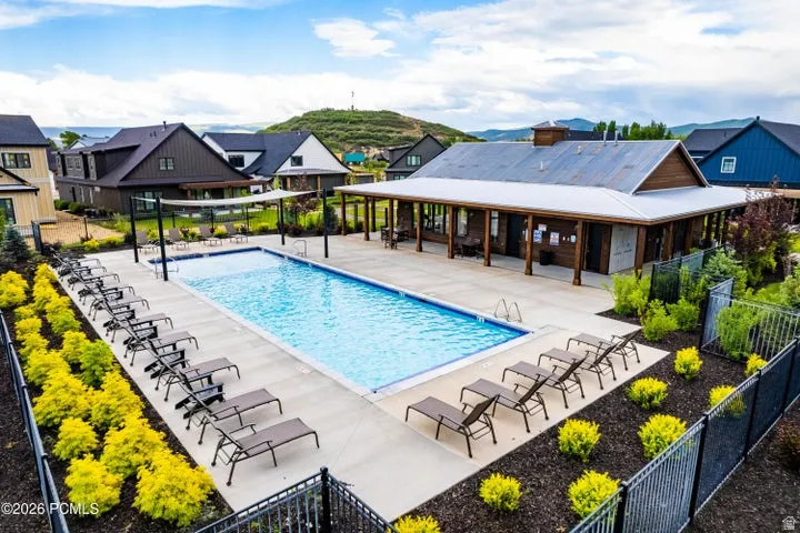 Outdoor swimming pool with integrated spa and surrounding concrete patio