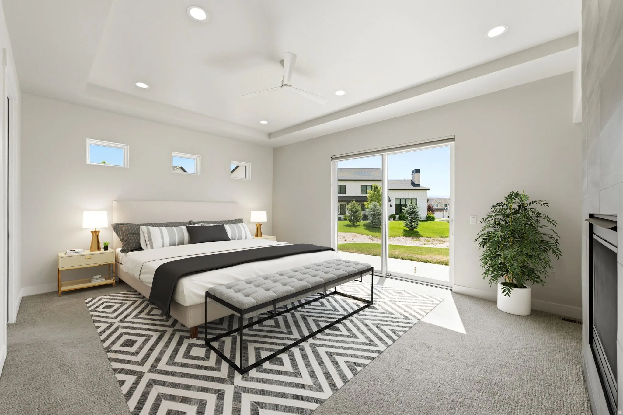 Spacious room featuring a tray ceiling, recessed lighting, ceiling fan, and large sliding glass door