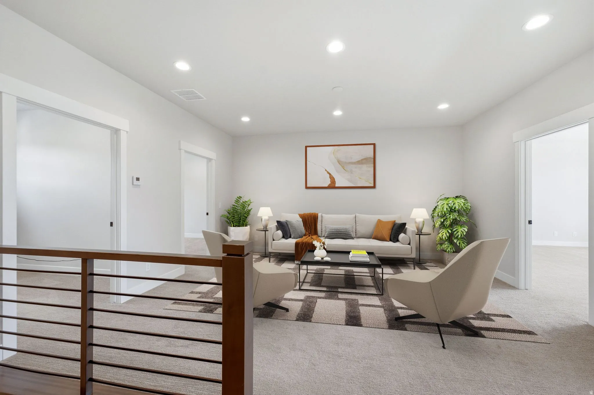 Spacious upper-level living area with recessed lighting, light-toned carpeting, and a wood and metal railing
