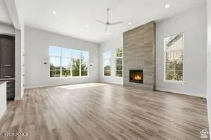 Spacious living area featuring high ceilings, recessed lighting, and wood-finish flooring