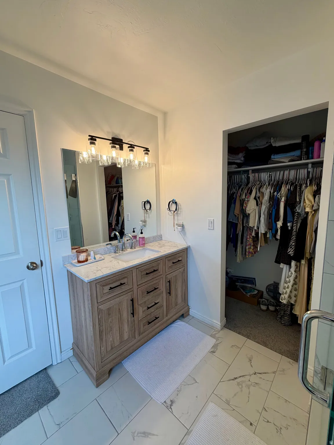 Wood-finish vanity with a single basin sink and stone-finish countertop