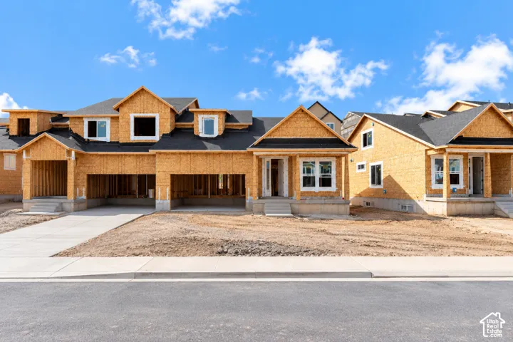 New construction residences featuring multiple rooflines, dormer windows, and attached garages