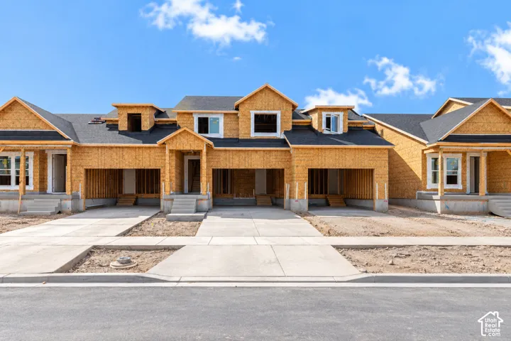 New construction property featuring asphalt shingle roofing, multiple dormer windows, concrete driveways, and covered front entrances