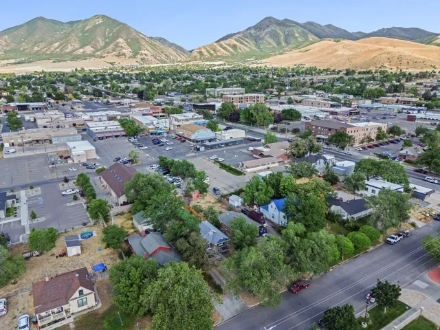Aerial perspective showcasing a mixed-use neighborhood with residential properties and commercial buildings