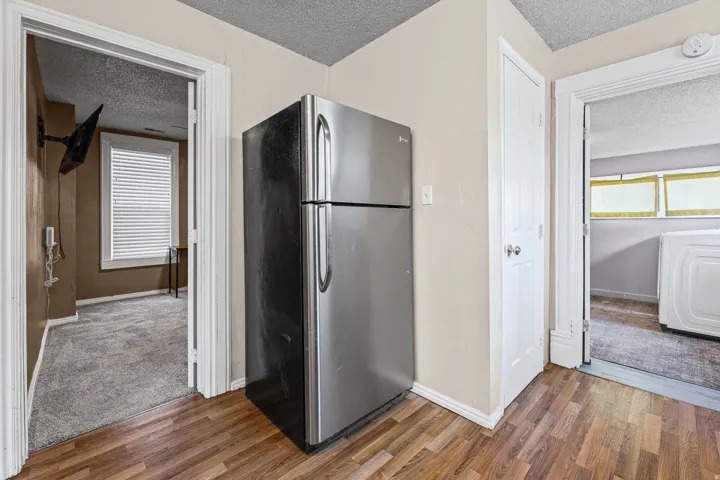 Stainless steel refrigerator with wood-finish flooring