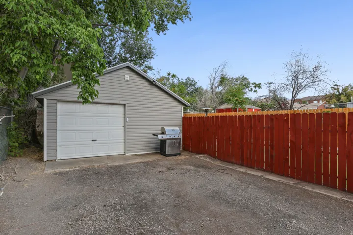 Detached garage featuring horizontal siding and a paneled overhead door