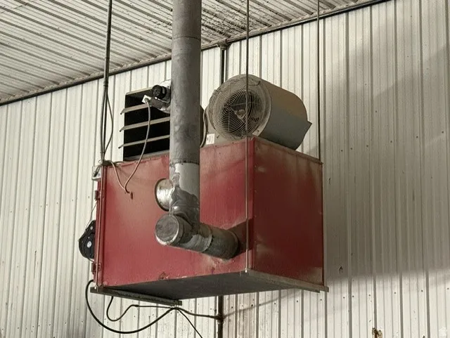Industrial overhead heating unit with exposed ductwork and fan assembly