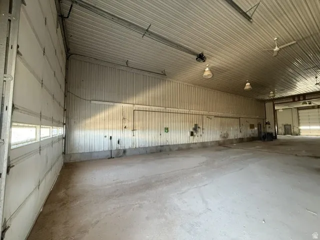 Spacious interior with concrete flooring and corrugated metal walls