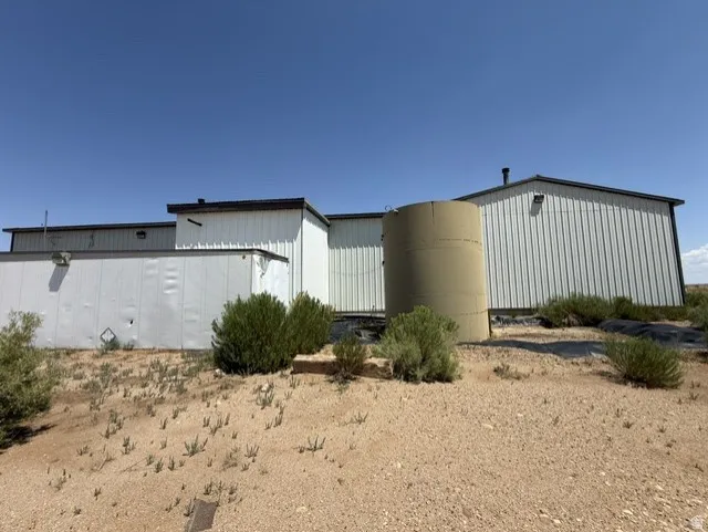 Industrial-style building featuring corrugated metal siding and a flat roofline