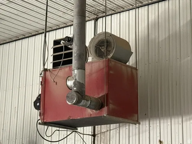 Industrial overhead heating unit with exposed ductwork and fan assembly