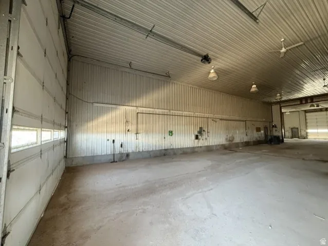 Spacious interior with concrete flooring and corrugated metal walls